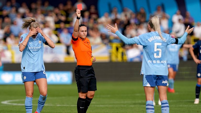 Alex Greenwood (R) is shown a red card after receiving a second yellow for time-wasting