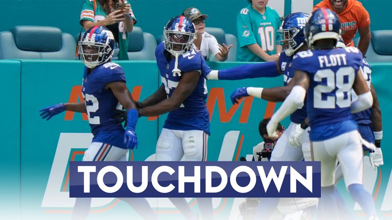 New York Giants safety Jason Pinnock (27) is congratulated by his teammates after he intercepted a pass and ran for a touchdown during the first half of an NFL football game against the Miami Dolphins, Sunday, Oct. 8, 2023, in Miami Gardens, Fla. (AP Photo/Wilfredo Lee)


